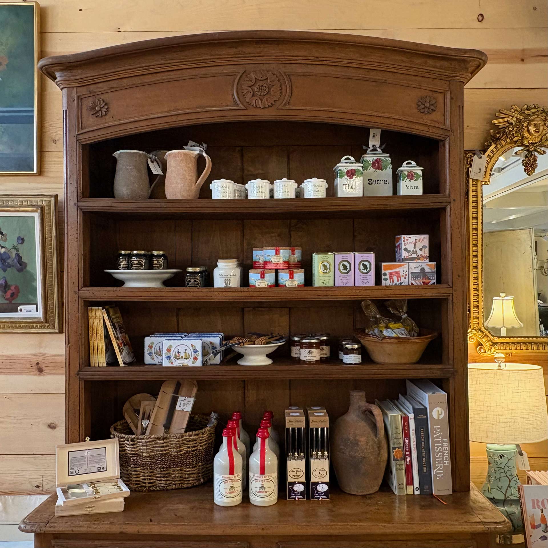 A close up of the hutch shelving stocked with French kitchenwares